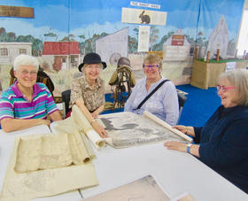 Helen Warman, Marion Warman, Marilyn Folger and Karen Moore, checking over some early maps.