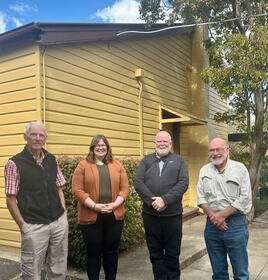 Honorary Curator Alastair Crombie, MLA Suzanne Orr, Ken Heffernan and Tony Morris out side the old Hall 'Bush school'.