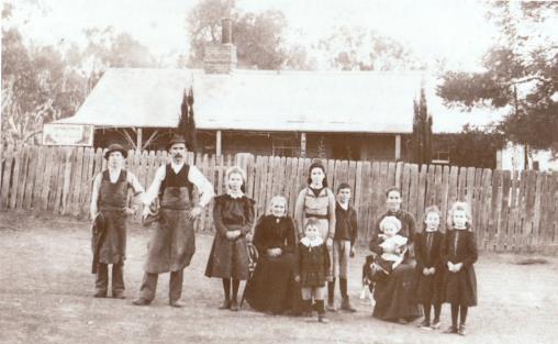 William and Louisa Morris in front of Dellwood homestead with their 8 children.